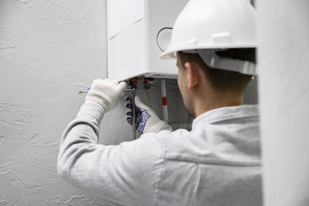 worker repairing electric boiler system